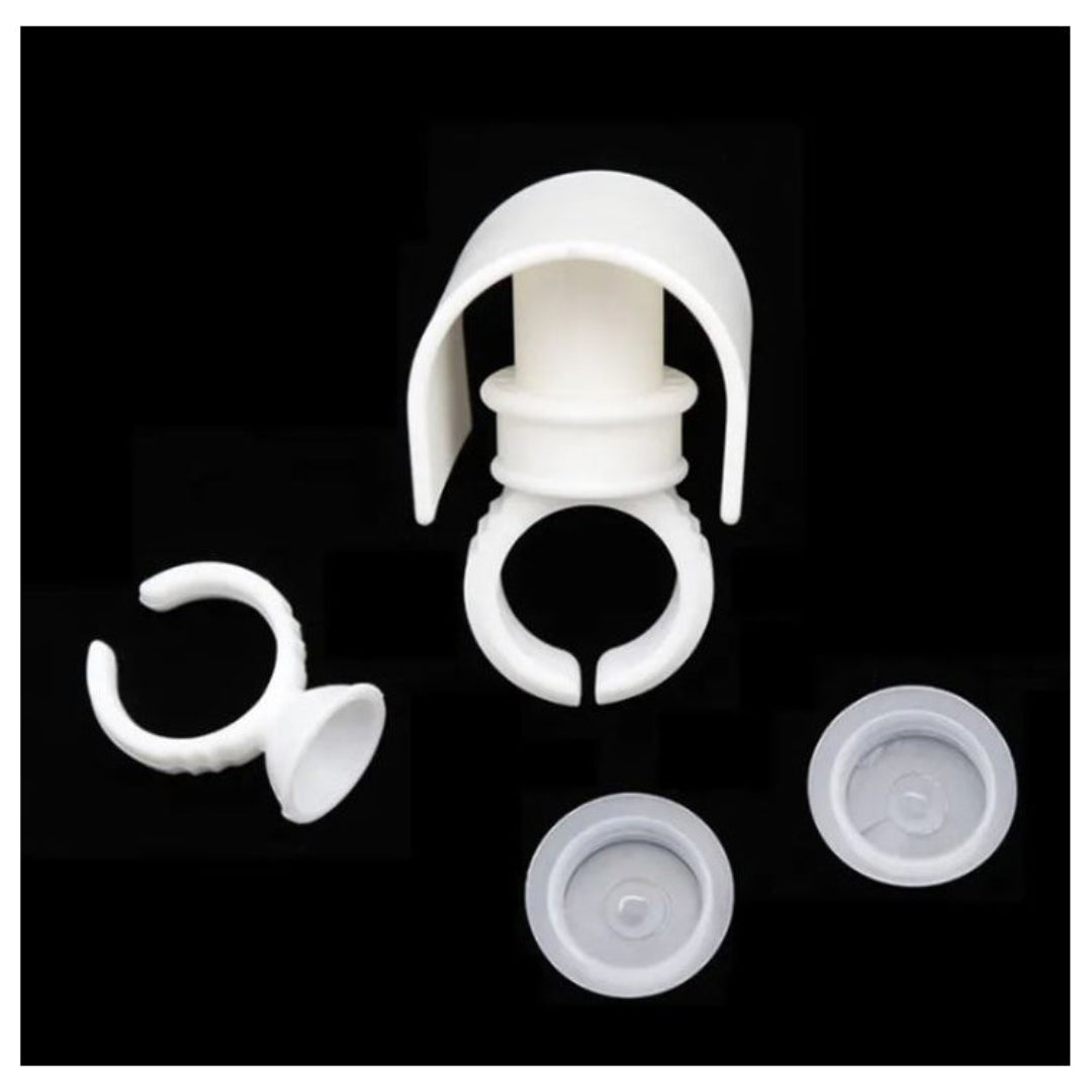 131800   A white plastic eyelash strip eyelash holder and ring with glue cup on top, with 2 aerial views of cup on right hand side on a back background