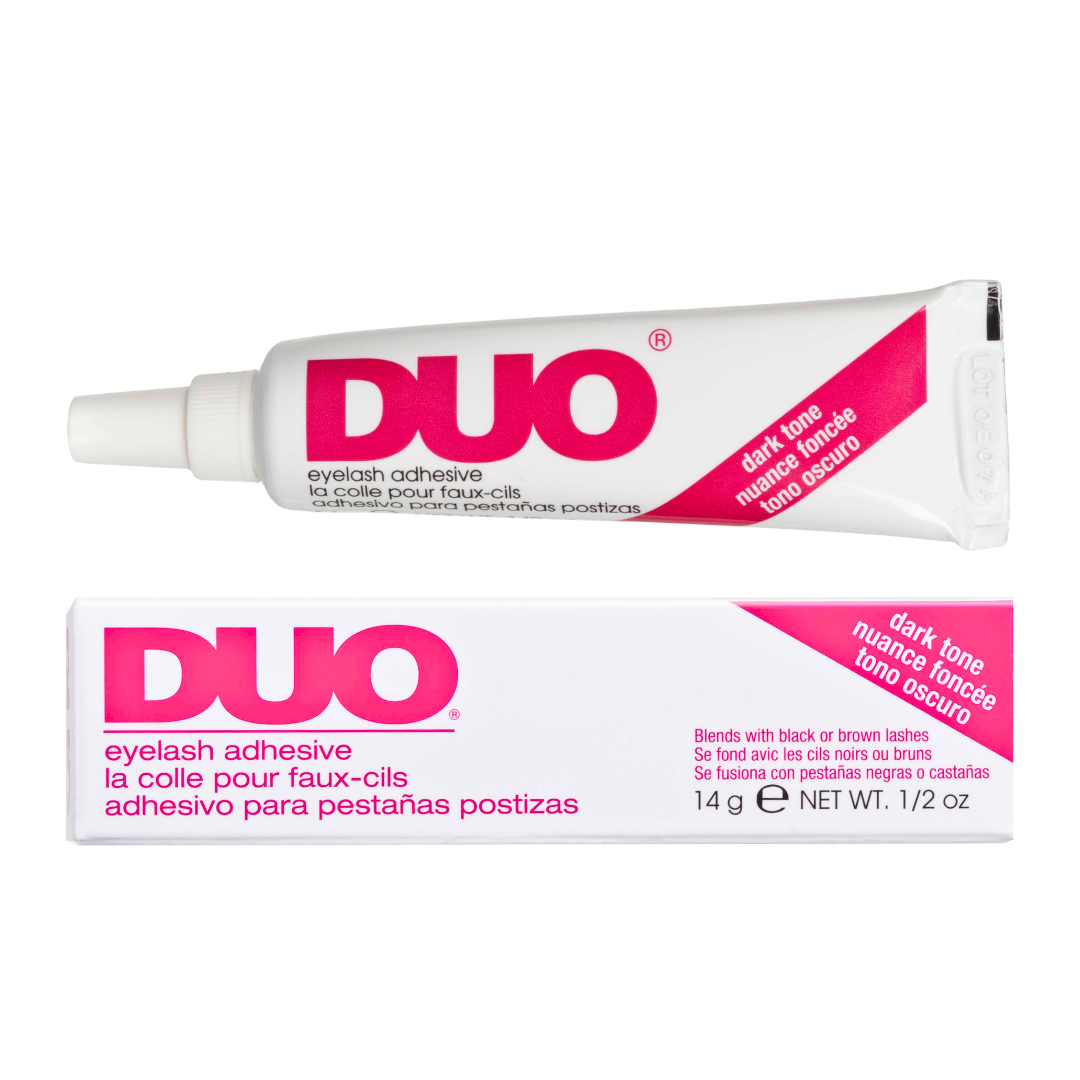 DUO eyelash adhesive shown as a white squeeze tube above its matching retail box on a plain white background. The packaging features bold pink branding and a pink diagonal label reading 'dark tone' with additional product text below.