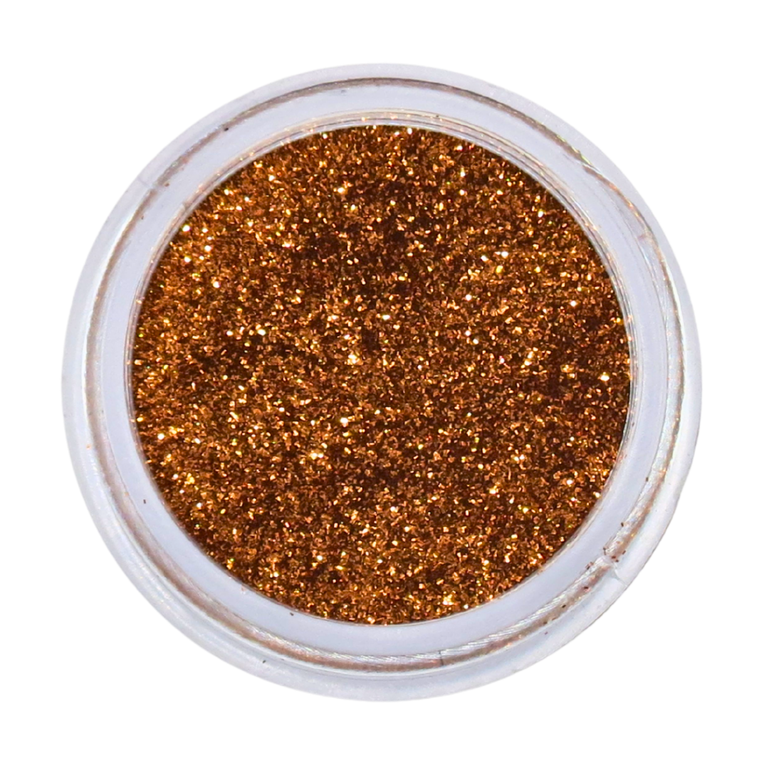 A top-down view of fine, sparkling copper-brown nail glitter in a small clear plastic jar, set against a solid white background.