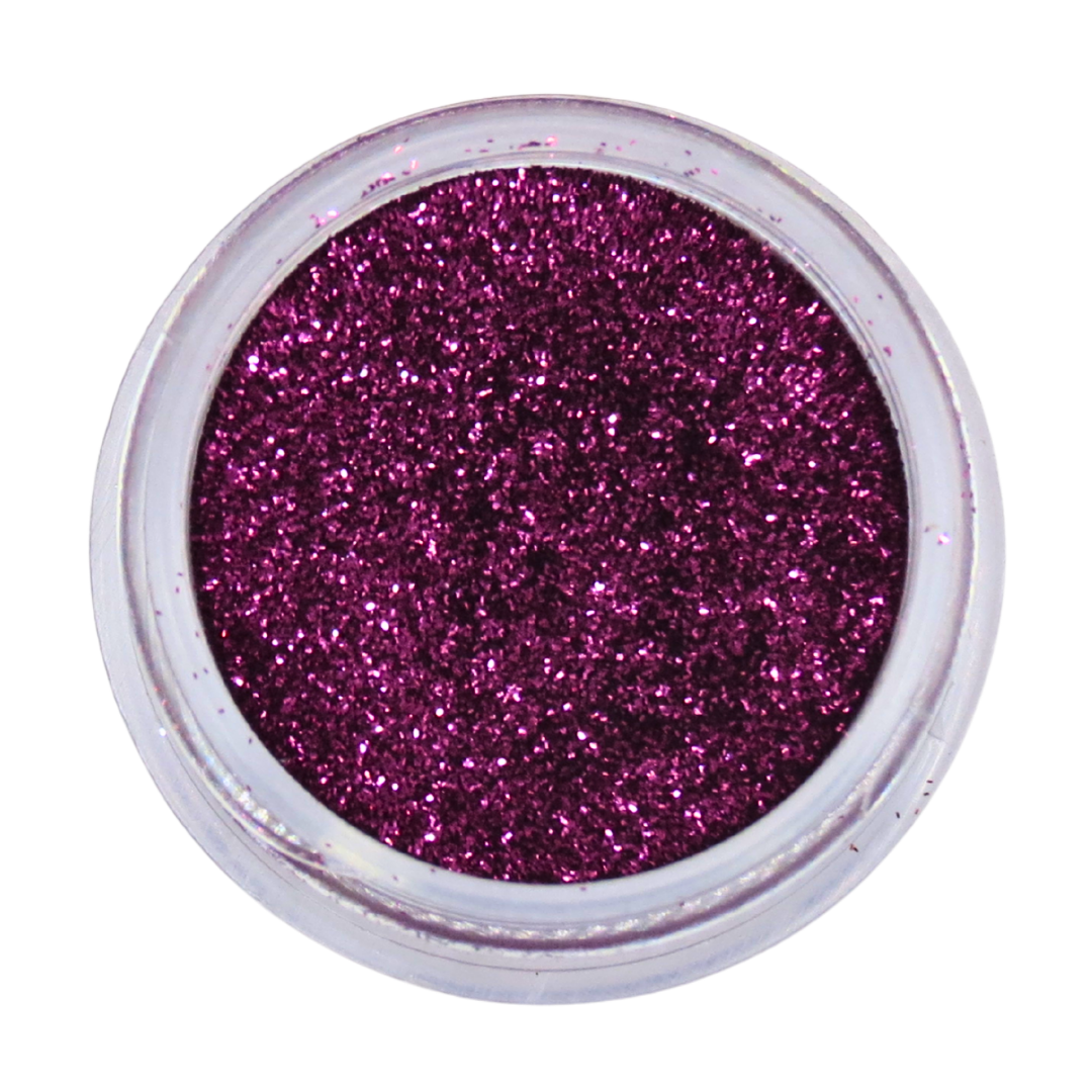 A top-down view of a small clear plastic jar filled with sparkling magenta-purple nail glitter powder, set against a plain white background.