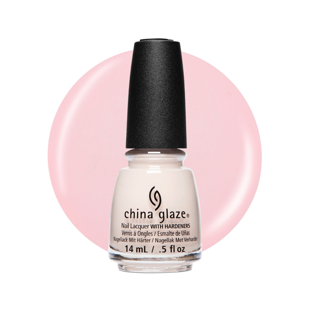A bottle of China Glaze nail polish with hardeners, featuring a black cap and a white bottle, set against a light pink circular color swatch on a white background.