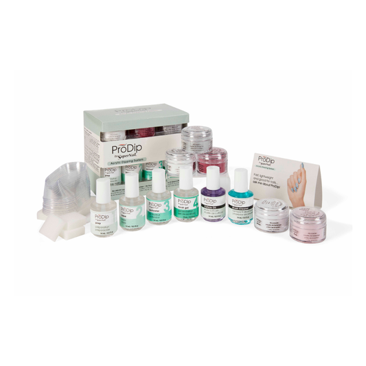 A ProDip nail dip powder kit arranged on a white background, including multiple bottles of different prep and topcoats, colored dip acrylic powder, jars with French acrylic colours, a stack of clear dipping bowls, a box, an instruction card, and a small hand sample card.