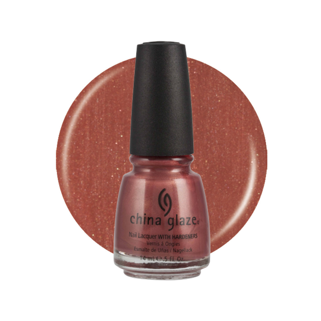A bottle of China Glaze nail polish with a black cap, shown in front of a circular swatch of the glittery copper-rose polish color on a white background.