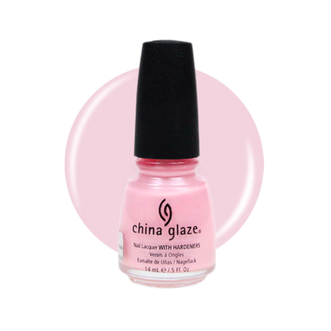 A bottle of China Glaze nail polish in a light pink shade, featuring a black cap and a circular pink background swatch behind the bottle.
