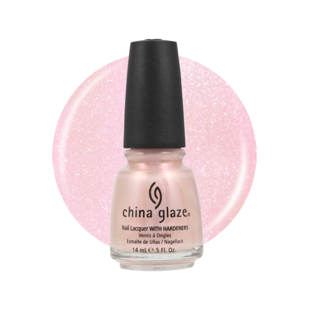 A bottle of China Glaze nail polish in a sparkling light pink shade, shown against a white background with a large matching pink glitter swatch behind it.