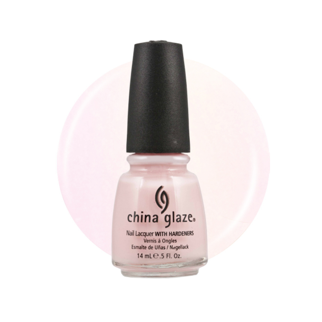 A bottle of China Glaze nail polish in a pale pink shade with a black cap, shown against a white background with a soft pink circular color swatch behind it.