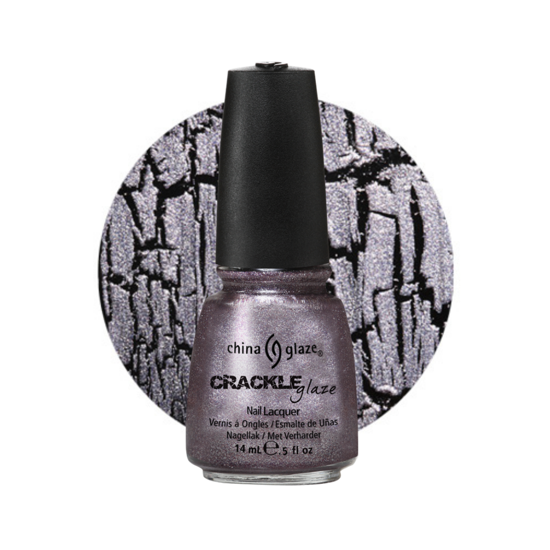 A bottle of China Glaze Crackle Glaze nail polish in a shimmery dark silver-gray shade, shown in front of a circular swatch displaying the crackle pattern of the lacquer.