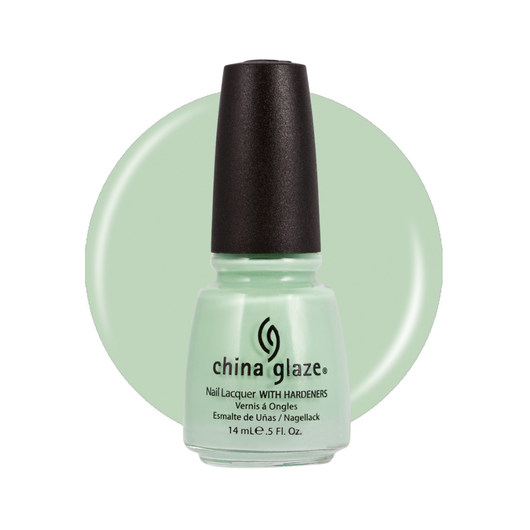 A bottle of China Glaze nail polish with a black cap, showing a pale mint green shade, set against a matching pale mint green circular background on a white studio backdrop.