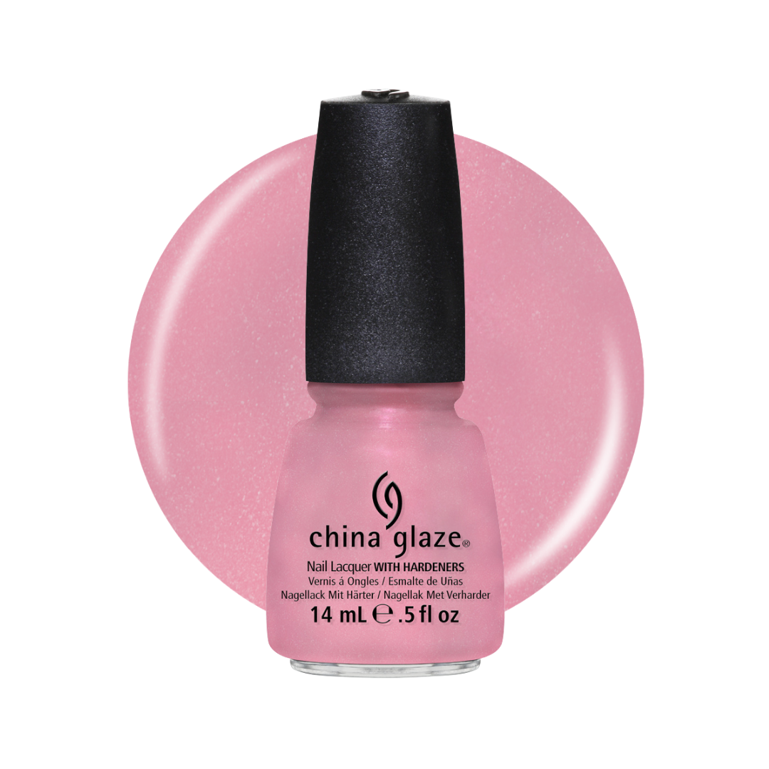 A bottle of China Glaze nail lacquer in the shade Magnolia, featuring a light pink glitter polish with a black cap, set against a matching pink circular color swatch on a white background.
