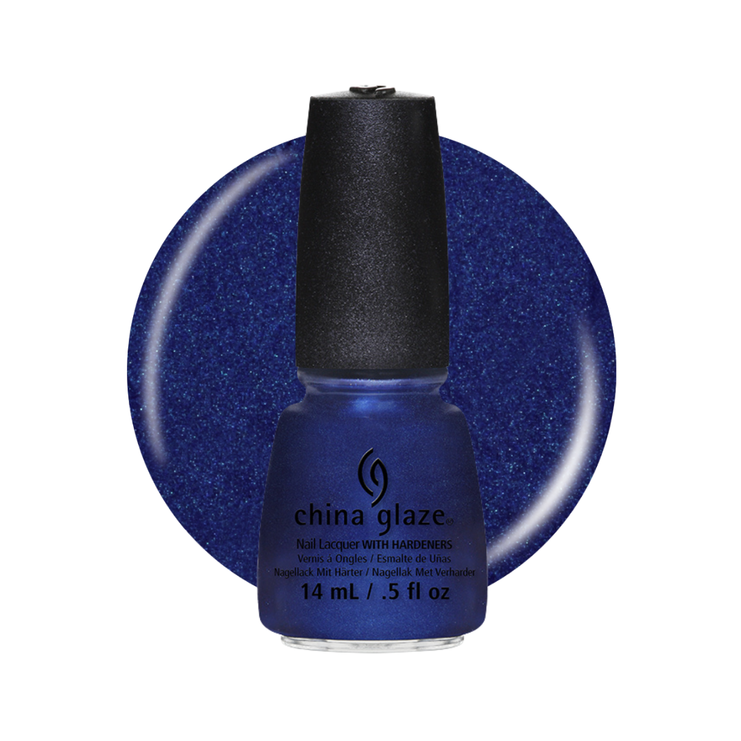 A bottle of China Glaze nail polish with a black cap, shown in front of a large circular blue swatch of the glittery cobalt blue polish. 