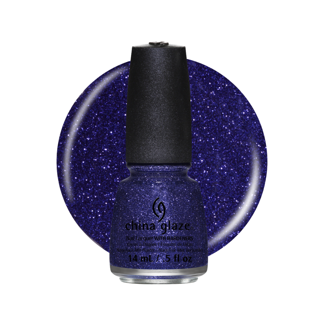 A bottle of China Glaze nail lacquer in a dark glittery blue shade, shown in front of a large circular swatch of the same blue glitter polish on a white background.