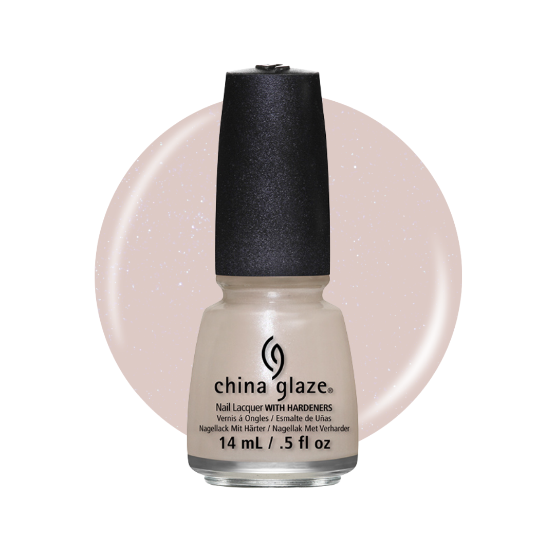 A bottle of China Glaze nail polish with a black cap, shown against a white background with a large circular swatch of the light champagne glitter polish color behind it.