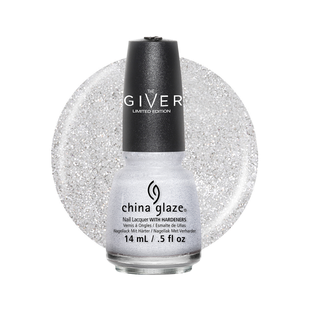 A bottle of China Glaze 'The Giver' Limited Edition nail polish, featuring a black cap and a clear bottle showing a sparkling silver glitter lacquer, set against a matching glittery circular background on a white studio backdrop.
