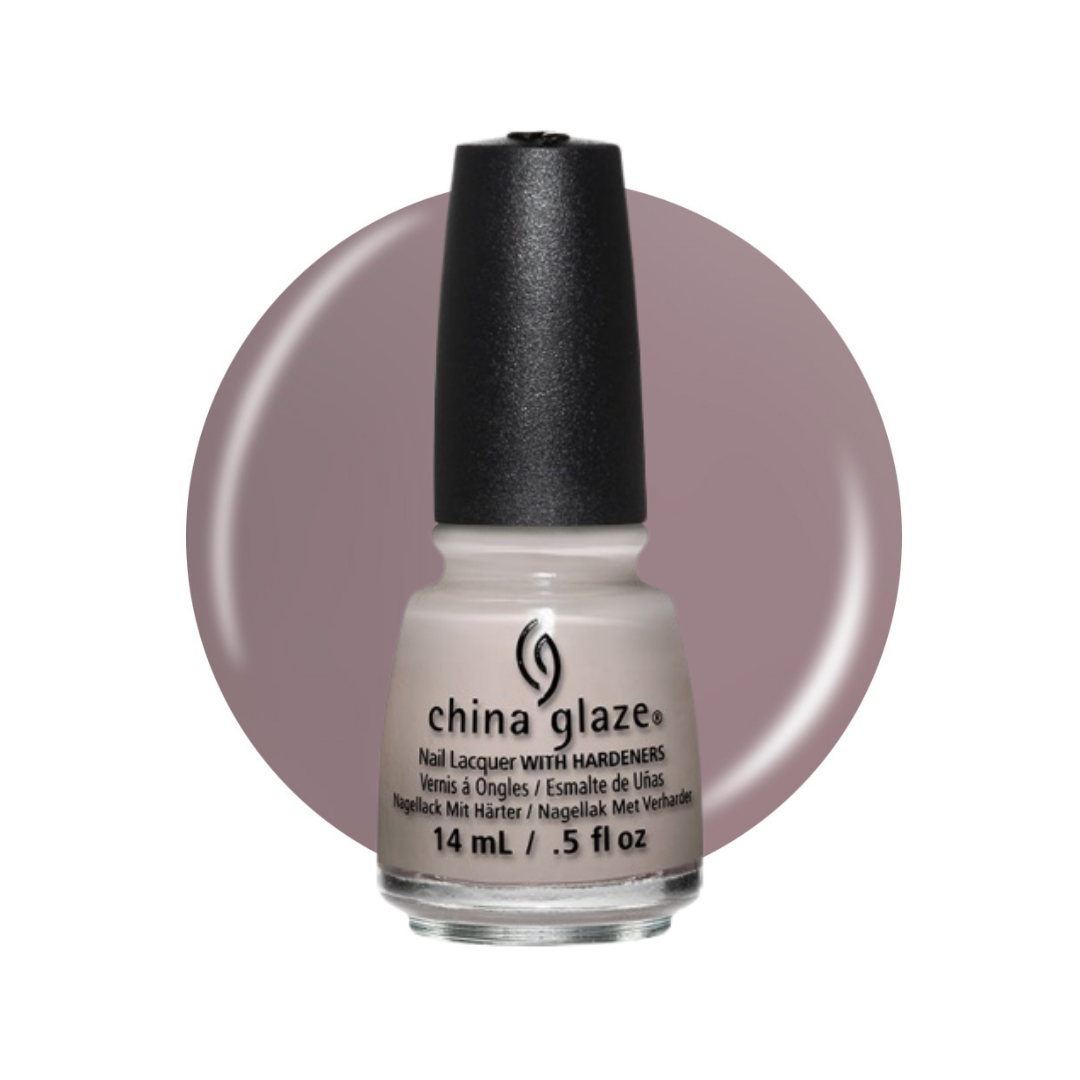 A bottle of China Glaze nail polish with a black cap and a light warm gray/taupe shade, set against a circular mauve-pink color swatch on a white background.