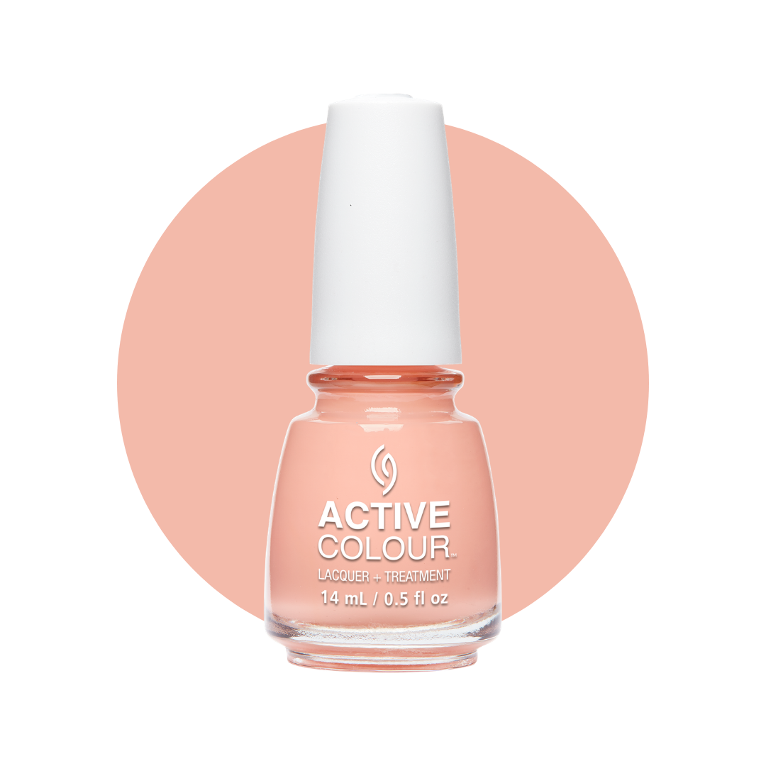 A bottle of China Glaze Active Colour polish and Treatment nail polish in a soft peach-pink shade, set against a white background with a large peach-pink circular color swatch behind it.