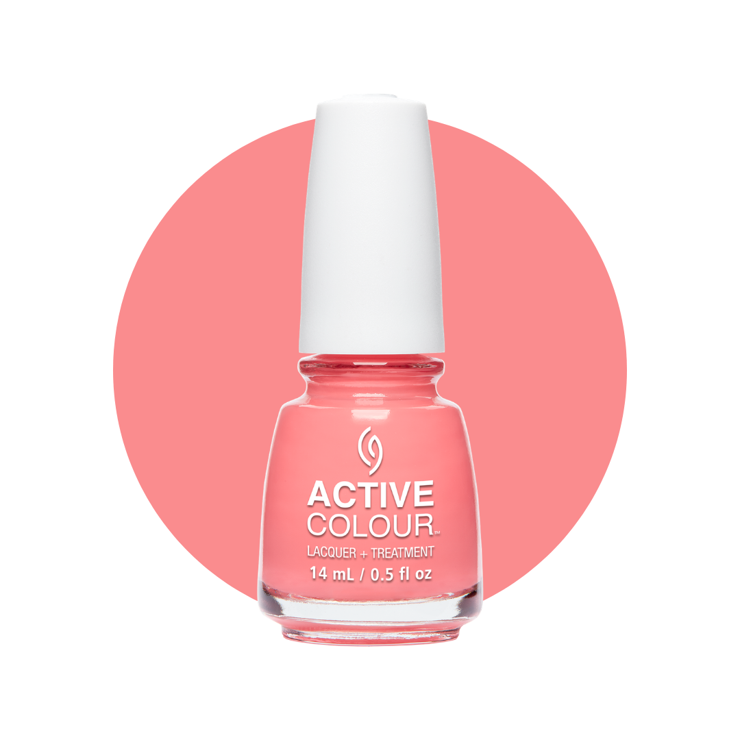 A bottle of Active Colour nail polish in a coral pink shade, set against a white background with a large matching pink circle behind it.