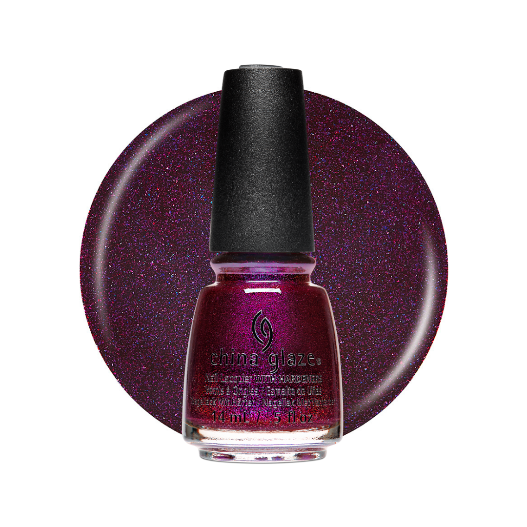 A bottle of Shiny Glaze nail polish in a sparkling deep purple shade, set against a matching circular swatch on a white background.