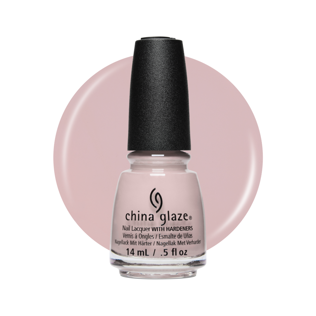 A bottle of China Glaze nail polish with hardeners in a pale pink shade, shown against a white background with a large matching pink color circle behind it.