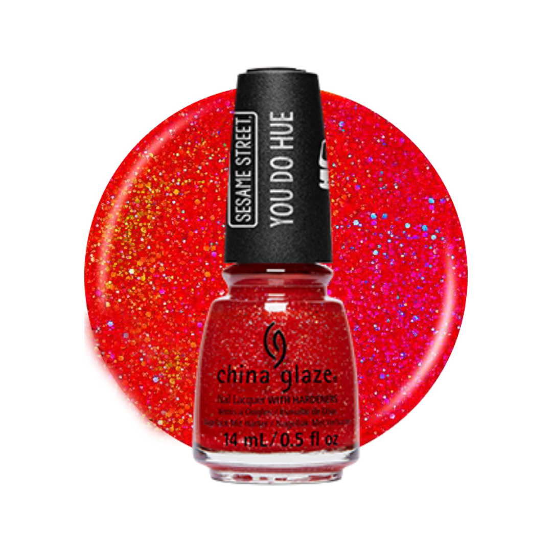 A bottle of China Glaze nail polish with a black cap reading 'Sesame Street You Do Hue', shown in front of a large circular glitter swatch of the same bright red-orange shade on a white background.