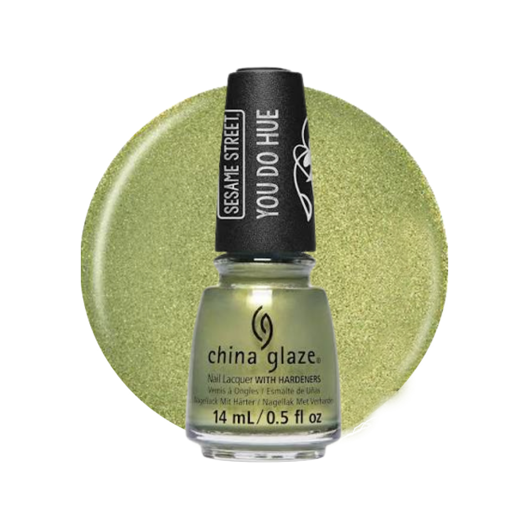 A bottle of China Glaze nail polish with hardeners, featuring a shimmering light olive green color shown both in the bottle and as a circular swatch behind it.