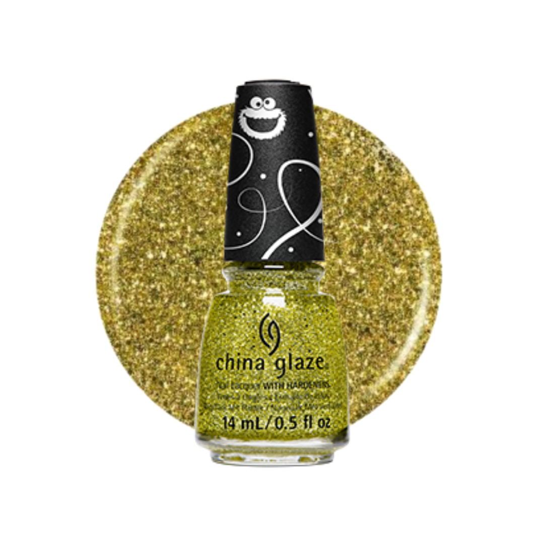 A bottle of China Glaze nail polish in a sparkling chartreuse yellow-green shade, shown in front of a circular glitter swatch of the same color. The bottle has a black cap decorated with a white cartoon face and swirls.