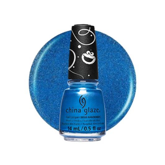 A bottle of China Glaze nail polish in a bright blue glitter shade, shown in front of a matching blue glitter circular swatch on a white background. The bottle has a black cap with white cartoon-like swirls and smiley faces.