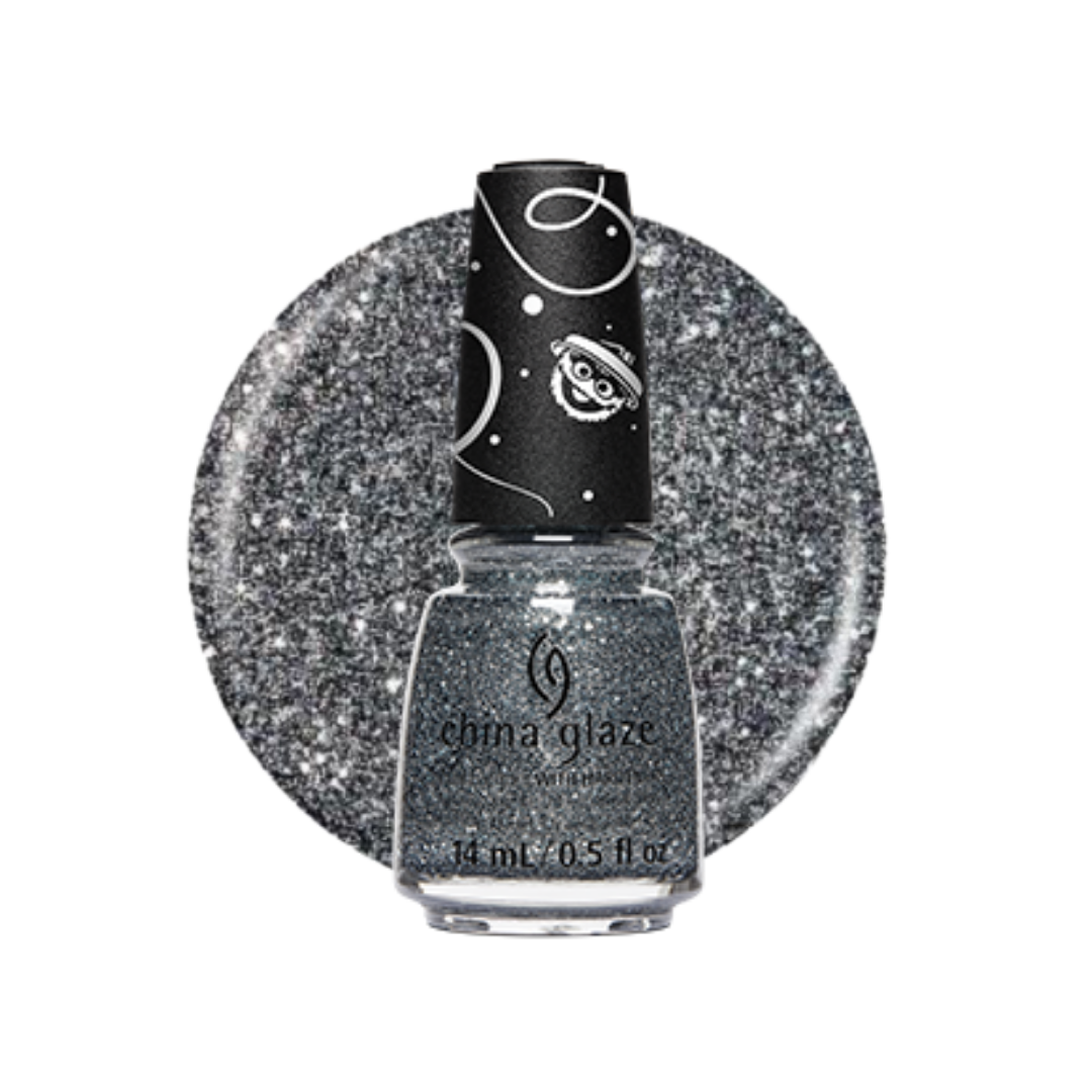 A bottle of China Glaze glitter nail polish in a sparkling silver-gray shade, shown in front of a matching circular glitter swatch on a white background.