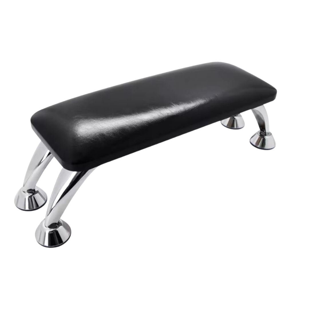 A black faux-leather padded manicure nail arm rest with four polished chrome legs, shown on a plain white background.