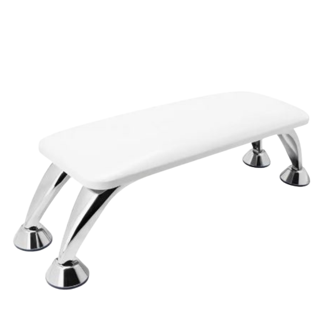 A white padded hand rest, for manicures and nail,s with four polished chrome legs, shown on a plain white background.
