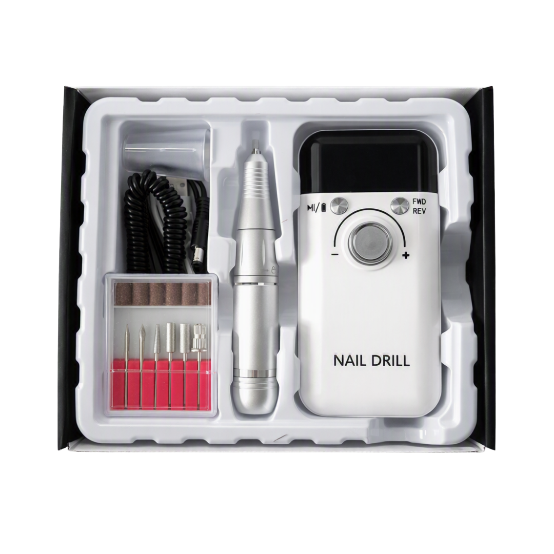 A white electric nail drill kit with a digital display screen, rotary control dial, and silver nail drill pen, presented in its white foam tray packaging with various drill bits and a black cord inside a black box.