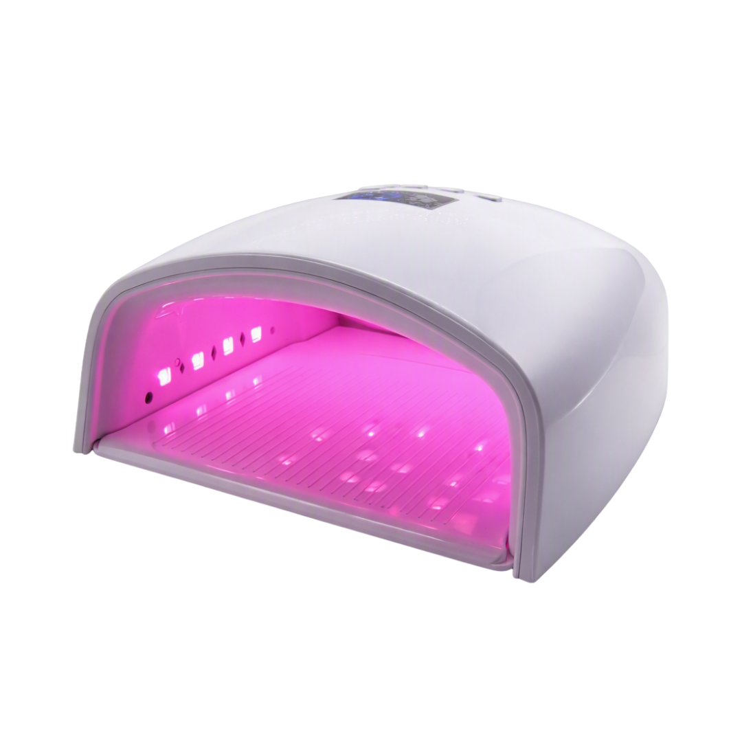 A white UV/LED nail lamp machine glowing with bright pink light inside, shown on a plain white background.