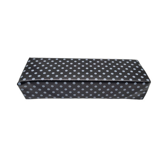 A rectangular nail manicure arm rest in black vinyl with a light gray polka dot pattern, shown against a plain white background.