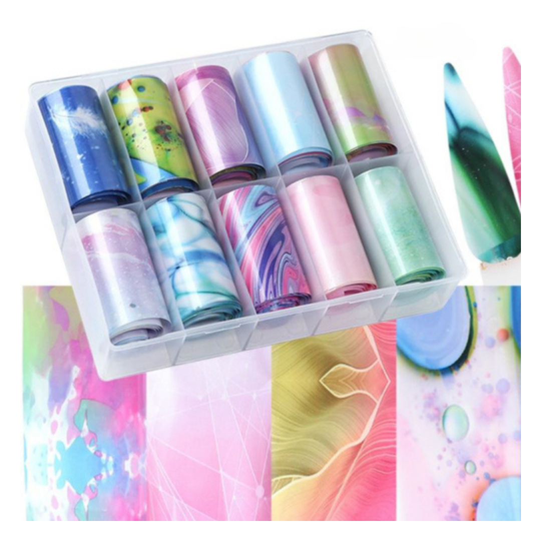 A clear plastic organizer tray holding multiple rolls of nail foil wrap or sticker material in assorted marbled and solid colors, with several sample swatches shown beside and below the tray.