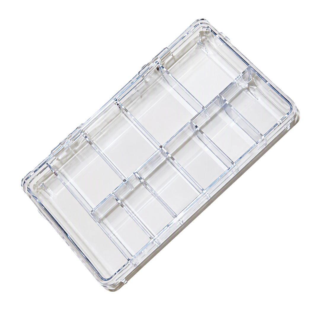 A clear plastic multi-compartment organizer tray with multiple rectangular sections, shown at an angle on a white background.