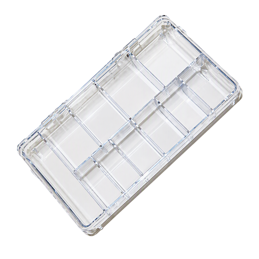 A clear plastic multi-compartment organizer tray with multiple rectangular sections, shown at an angle on a white background.