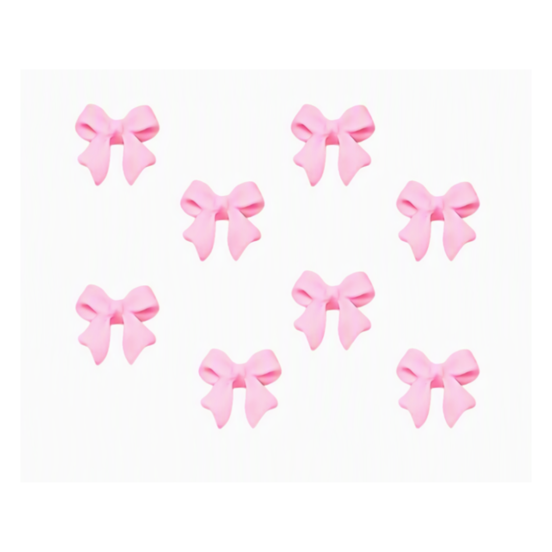 Nine small pink bow-shaped accessories arranged on a plain white background.