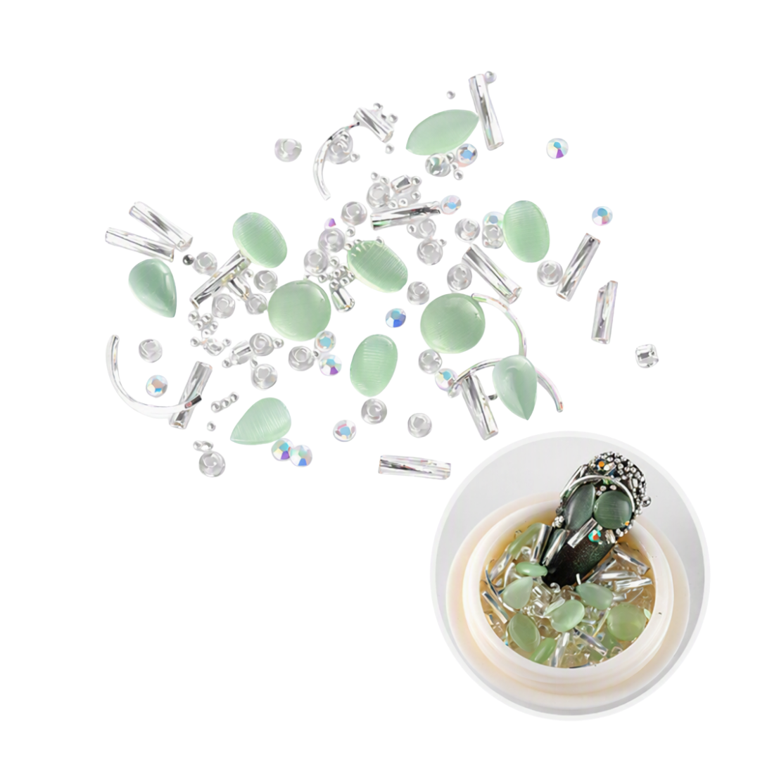 A flat-lay of light green teardrop-shaped cabochon beads and silver metal findings scattered on a white background, with a small inset showing the beads arranged in a clear dome.