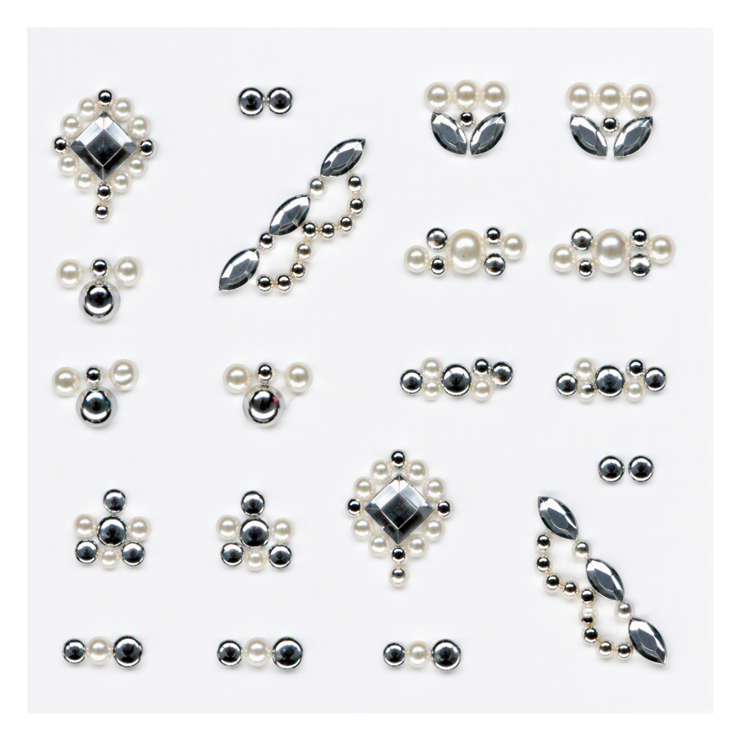A set of nail art embellishments featuring faux pearls and metallic silver elements in various shapes, including floral clusters, teardrop drops, and elongated marquise links, arranged on a plain white background.