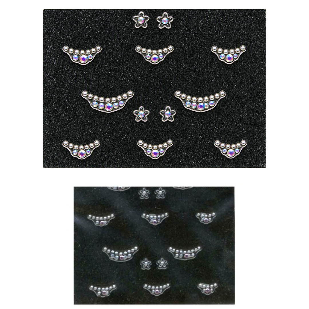 Two black cards showing silver crescent-shaped stud nail art with small clear rhinestones and purple center stones, plus small flower-shaped studs, on a white background.