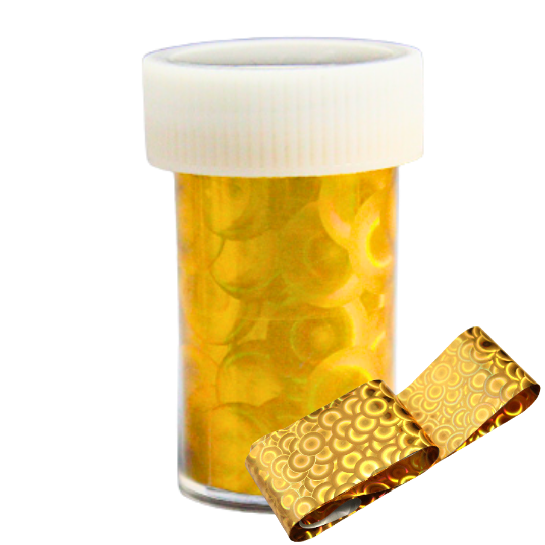 A clear plastic pill bottle with a white ribbed cap, filled with round yellow-gold nail art foil shown on a white background with a rolled gold foil band in front.