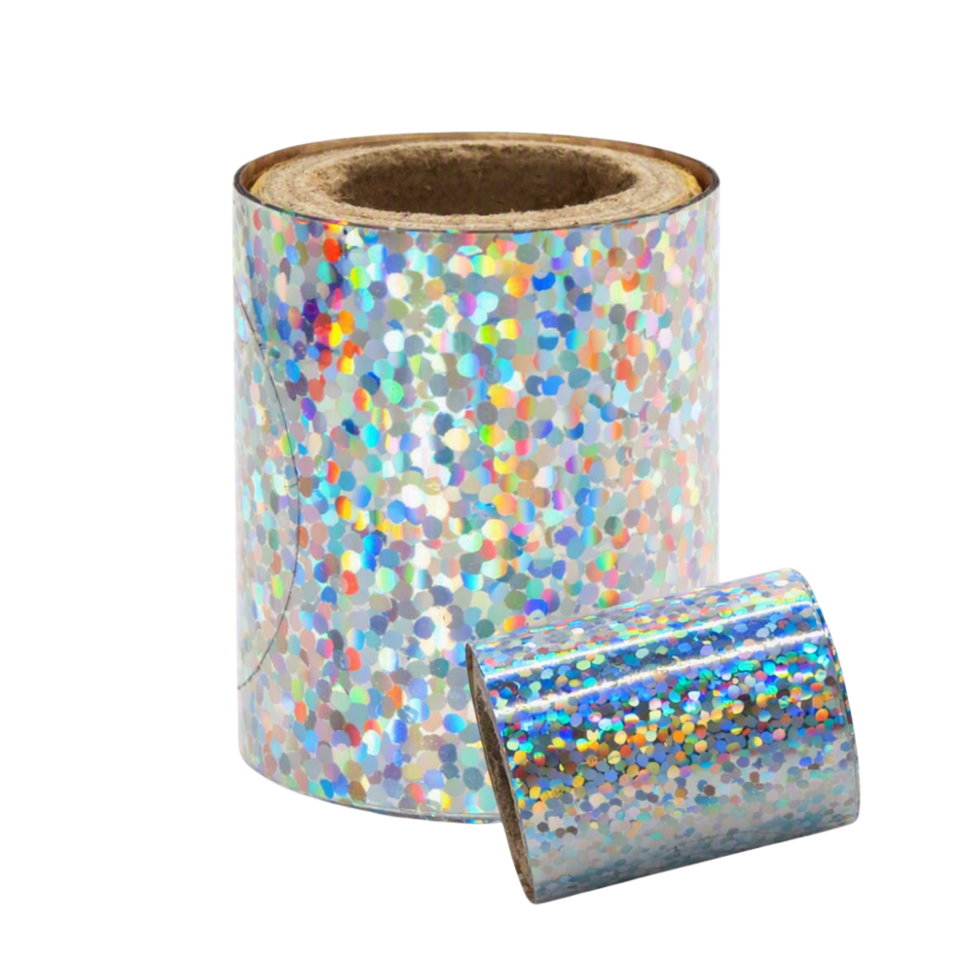 A roll of holographic glitter nail art foil with a silver base reflecting rainbow colors, shown with a smaller piece unrolled in front on a white background.