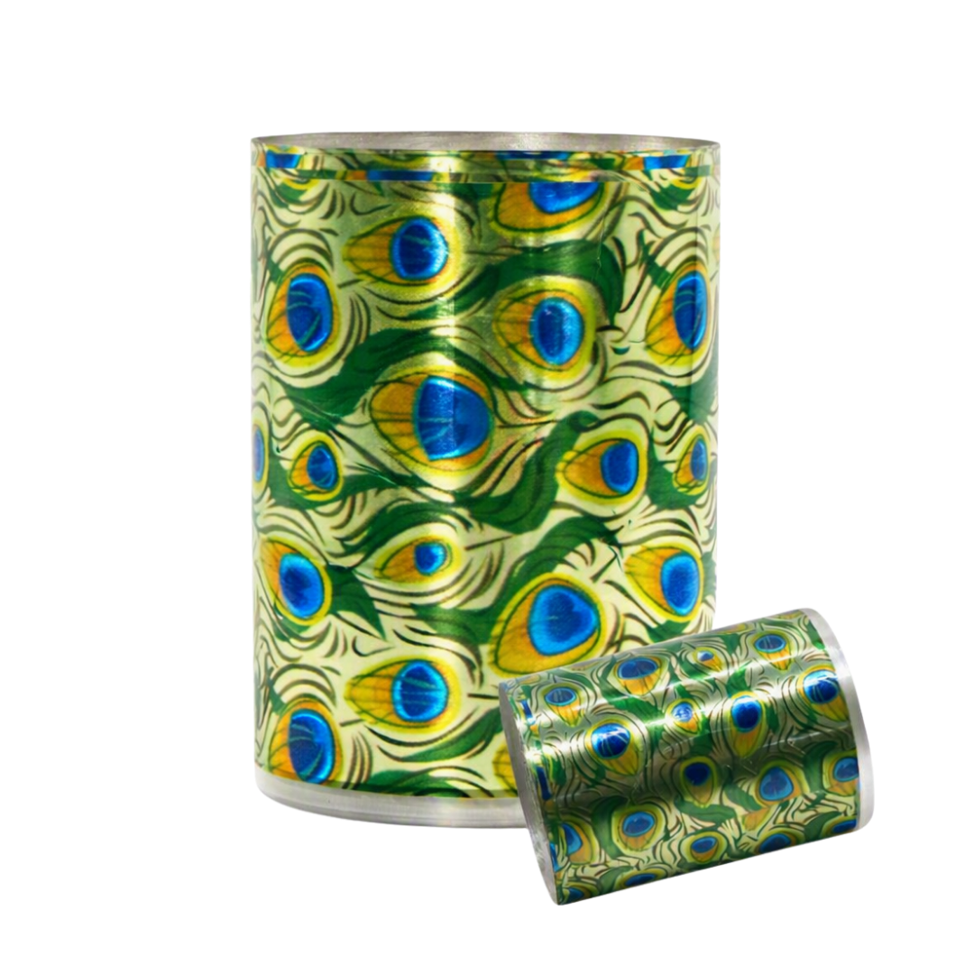 A roll of metallic peacock-feather patterned nail art foil, shown standing upright with a second roll lying on its side in front, against a plain white background.