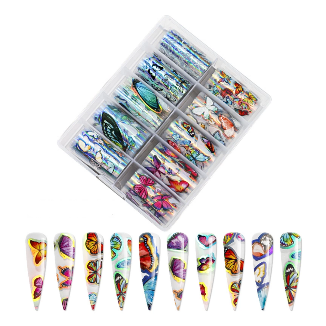 A clear plastic organizer tray holding multiple sets of nail art foil rolls decorated with colorful butterfly and floral designs, shown above a row of ten matching sample nail tips on a plain white background.