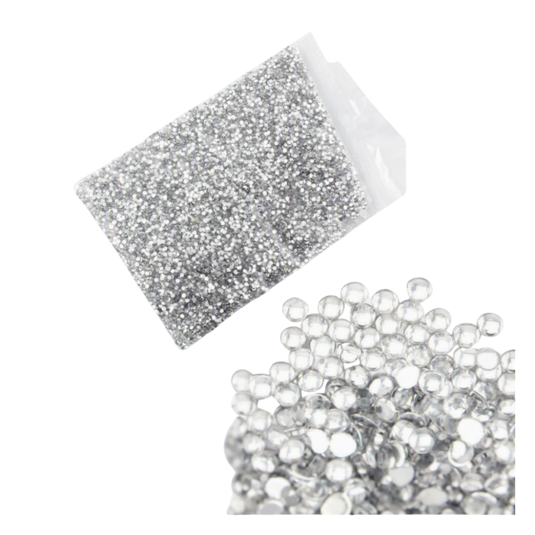 Silver round nail art rhinestone decorations on white background