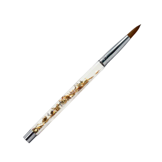 A fine point acrylic nail brush with a clear handle containing embedded gold flakes, a silver ferrule, and a brown bristle tip, shown on a plain white background.