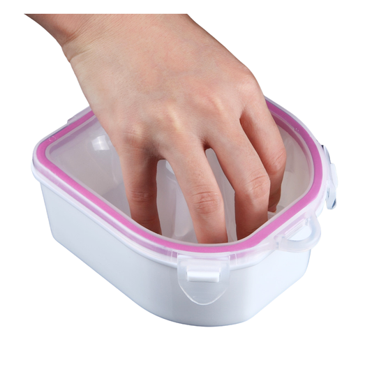 A hand reaching into a small white plastic hand soaking bowl with a translucent lid and pink rim, shown on a plain white background.