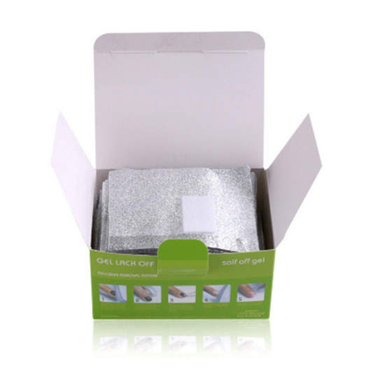 An open white cardboard box with green branding, containing several silver foil gel pads, photographed on a white background with a faint reflection below.