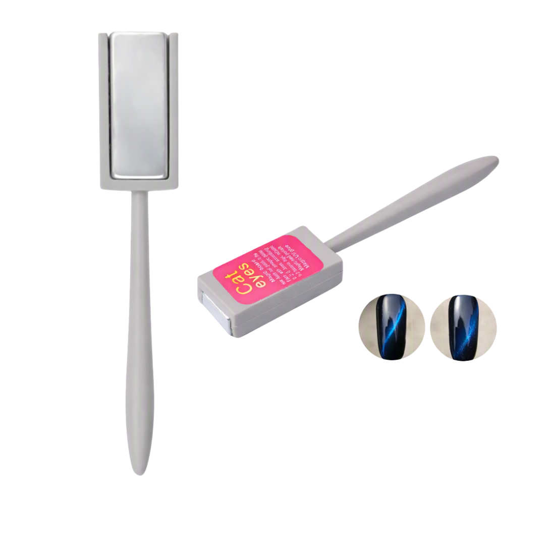 A gray magnetic nail art tool set on a white background, featuring a rectangular magnet, a slim wand with a pink label, and two circular insets showing a blue and black magnetic nail effect.