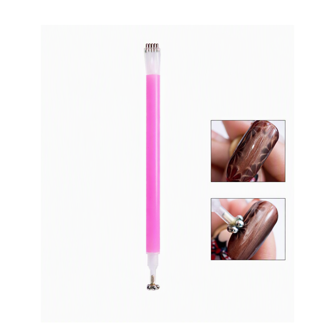 A pink dual-ended nail art tool with metal tips is shown on a white background, alongside two small inset photos demonstrating its use on a brown manicured nail.