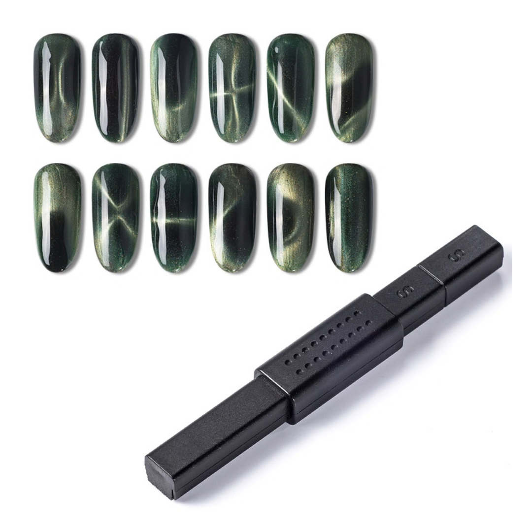 A black magnetic nail polish tool shown on a white background, with eight sample nail tips above it demonstrating a dark green to black cat-eye magnetic nail finish.